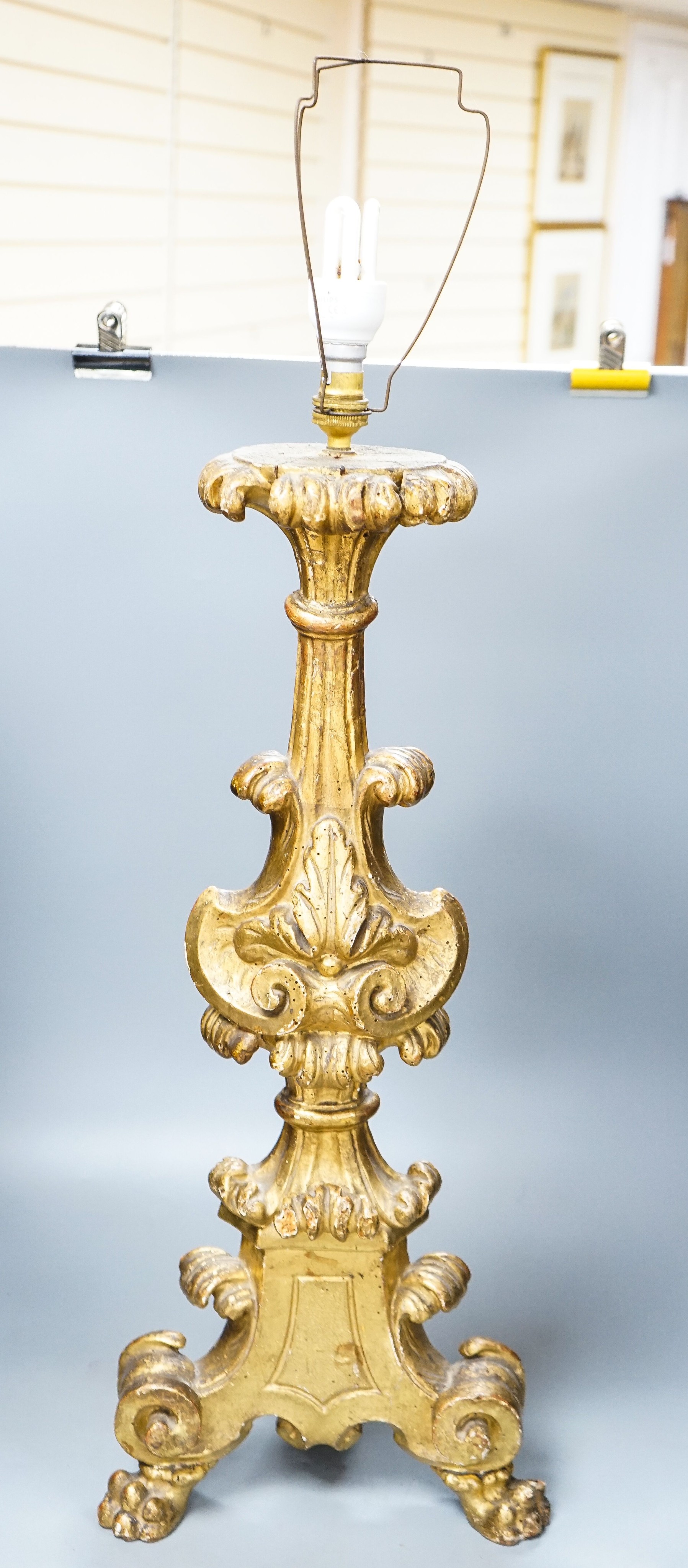 An 18th century Italian giltwood candlestand, foliate and scroll-carved